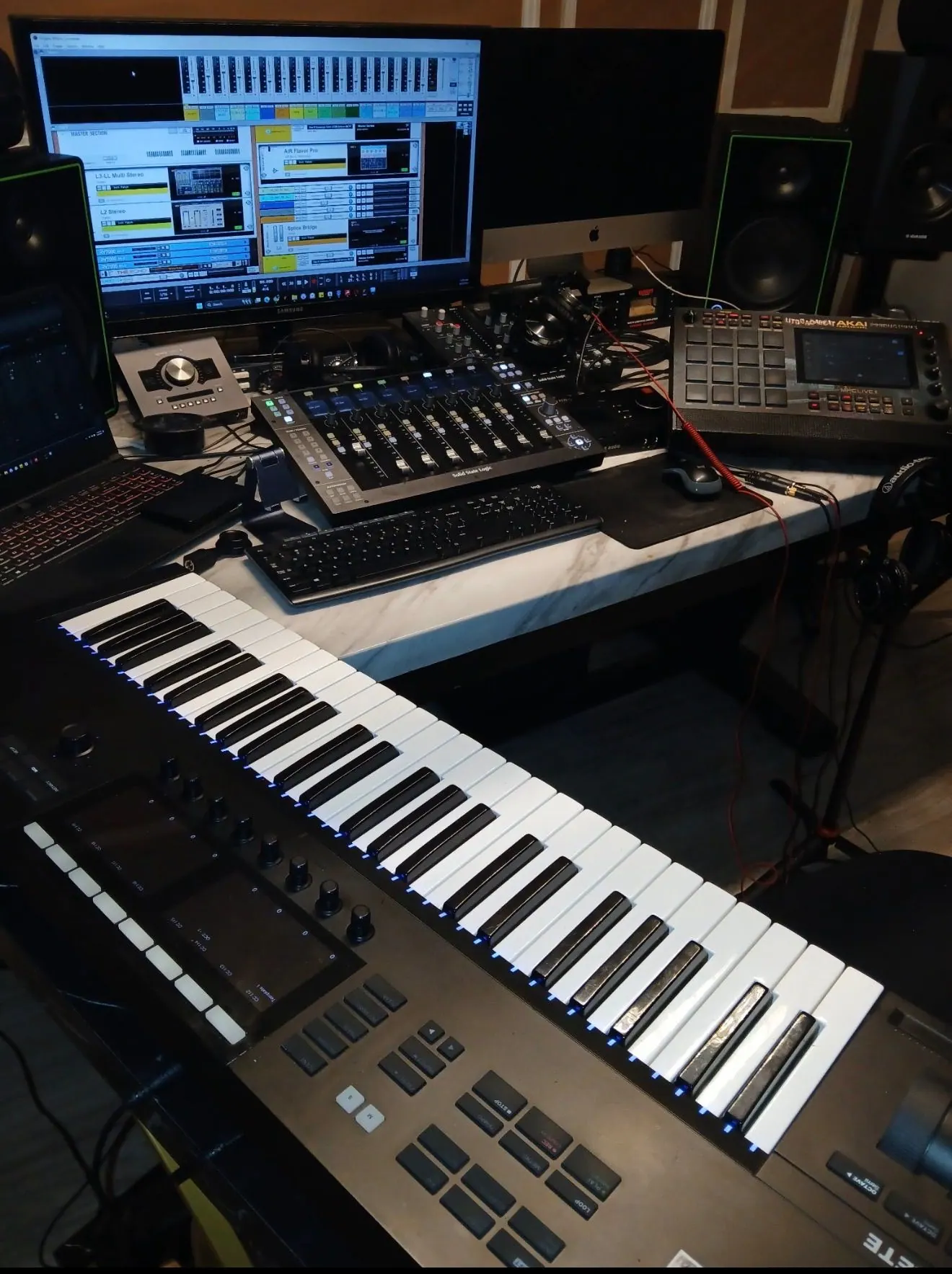 Game Time Studios production desk with MIDI keyboard, mixing surface, monitors, and beat machine